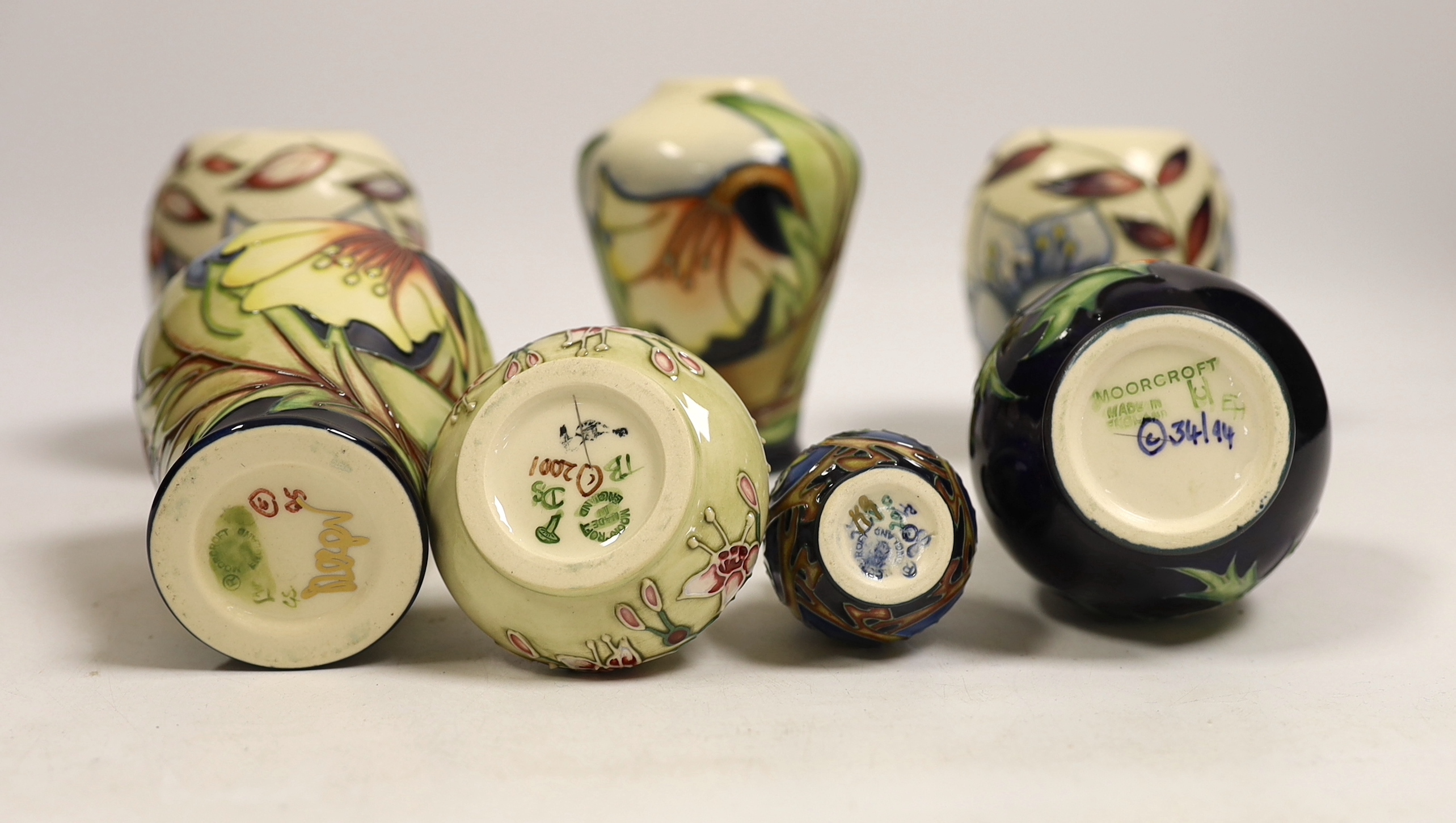 Seven small Moorcroft vases, various patterns. Tallest 10cm